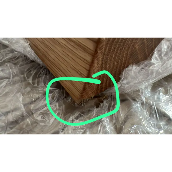 (As-is) Reno Dining Table 2.1m - 17 - Wooden plank with visible damage, plastic wrap covering, green circle highlighting