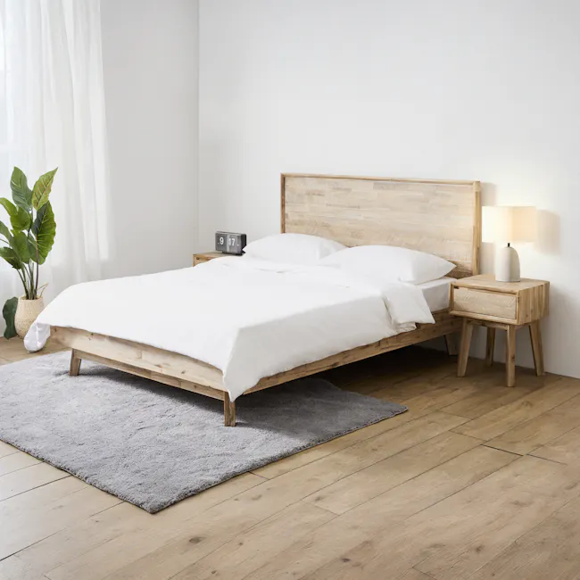 Leland Queen Bed - 2 - Wooden bed frame, white bedding, wooden nightstands, gray rug, light wooden flooring, natural light