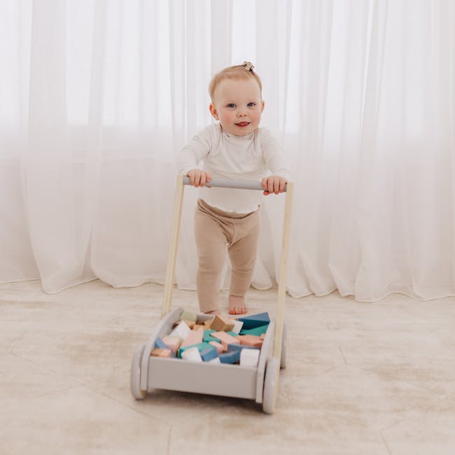 Bubble Wooden Baby Push Cart with 45 Buiding Blocks - 4 - White curtains, baby in white top, beige pants, wooden walker
