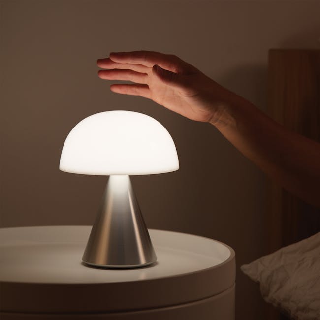 Lexon MINA L Led Lamp - Alu Poli - 3 - Modern bedside lamp, soft glow, illuminated dome, white lampshade, hand reaching for