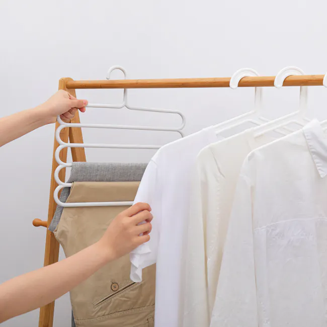 Multi Hanger - White - 3 - Clothes rack, white clothes, hanging clothes, hand holding clothes, organizing clothes, folding