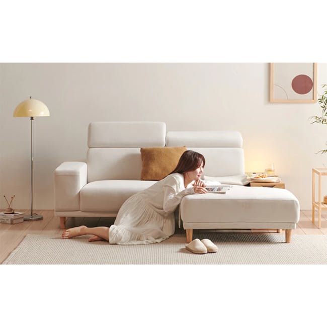Melysa Ottoman - Ivory (Eco Clean Fabric) - 14 - White sofa, woman reading, cozy room, minimalist decor, soft lighting