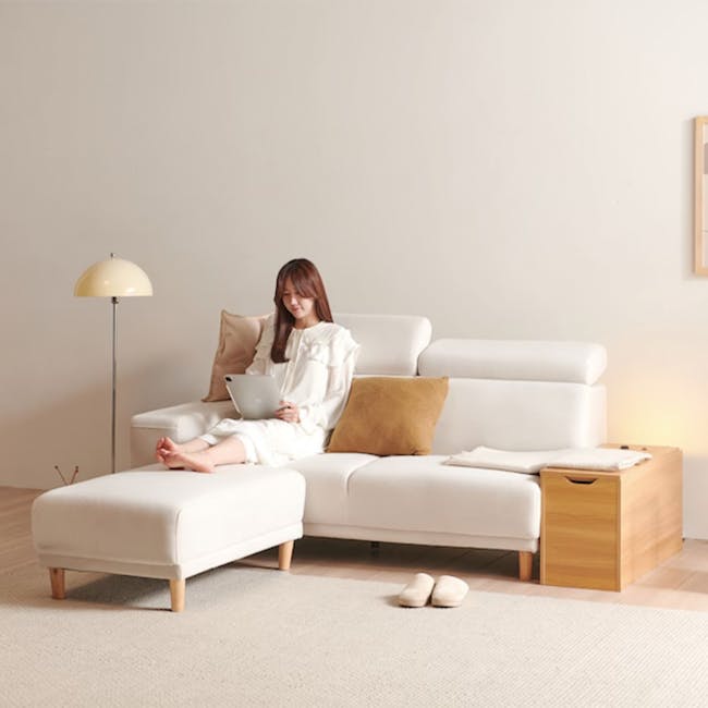 Melysa Ottoman - Ivory (Eco Clean Fabric) - 22 - White sofa, minimalist decor, woman in dress, laptop on lap, cozy living