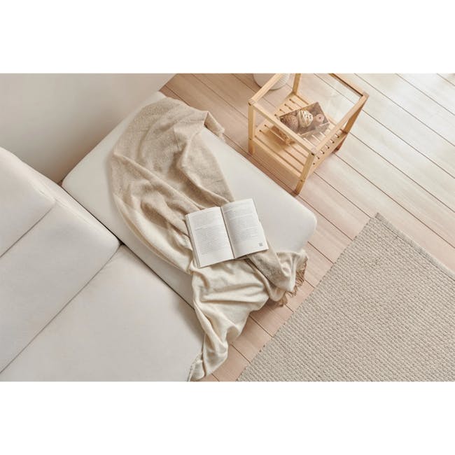 Melysa Ottoman - Ivory (Eco Clean Fabric) - 2 - Soft beige blanket, open book, cozy living room, minimalist decor, natural