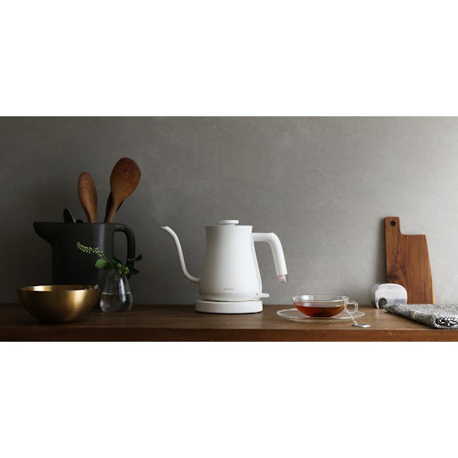 BALMUDA The Pot - White - 3 - Golden bowl, white kettle, black pot, wooden spoon, clear vase, green plant, wooden cutting