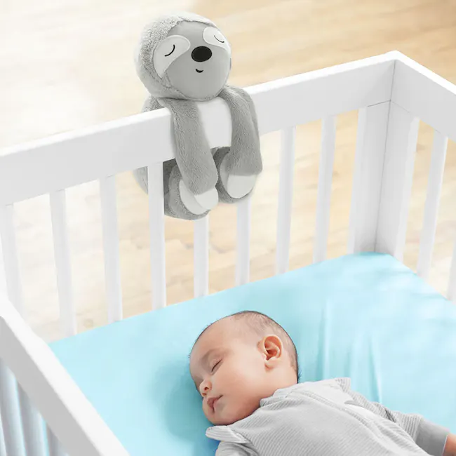 Skip Hop Cry Activated Soother - Sloth - 4 - Soft, cuddly gray stuffed animal, sleeping, baby lying, light blue mattress