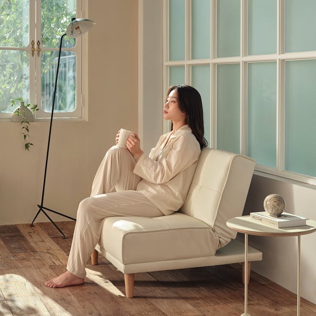 Candice 1 Seater Sofa Bed - Ivory (Faux Leather) - 5 - Sunlit room, cozy ambiance, soft lighting, natural light, indoor