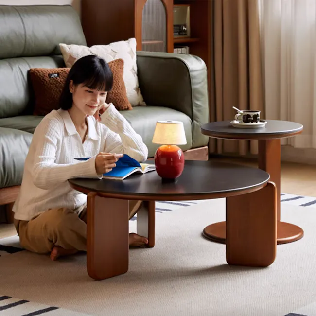Blair Round Side Table - Walnut, Black (Sintered Stone) - 10 - Sitting on the floor, reading a book, wearing a white
