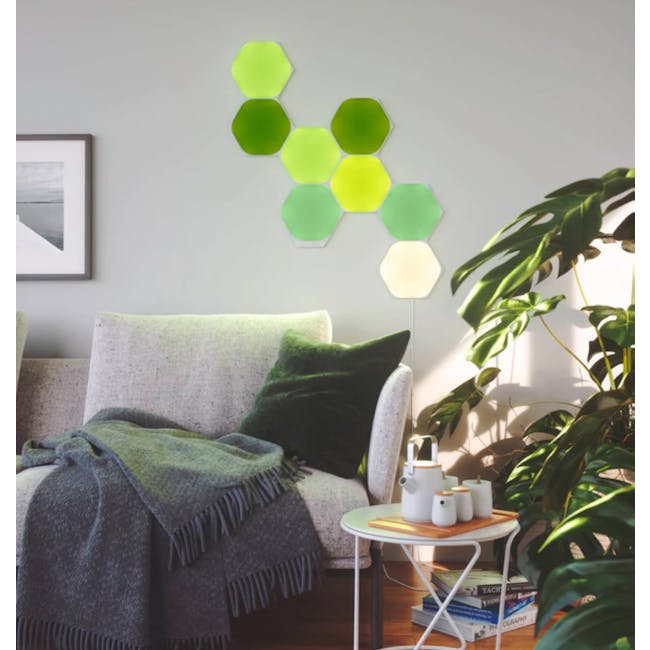 Nanoleaf Shapes Hexagons Smarter Kit (9 Panels) - 5 - Modern living room, cozy sofa, green cushions, gray throw blanket