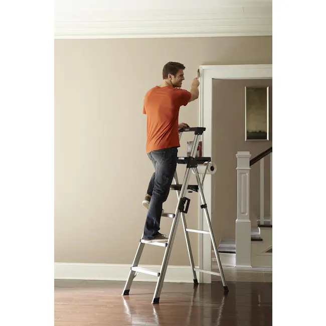 Cosco 4 Steps Signature Aluminium Ladder - 2 - standing man on ladder, orange shirt, blue jeans, wooden floor, white wall
