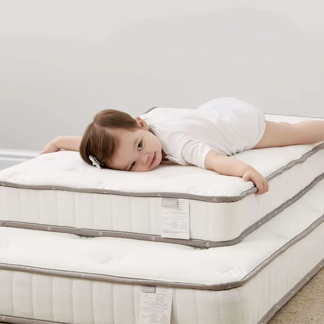Boori Single Bed Pocket Spring Mattress - 3 - White mattress with gray edges, baby lying on top, soft mattress material