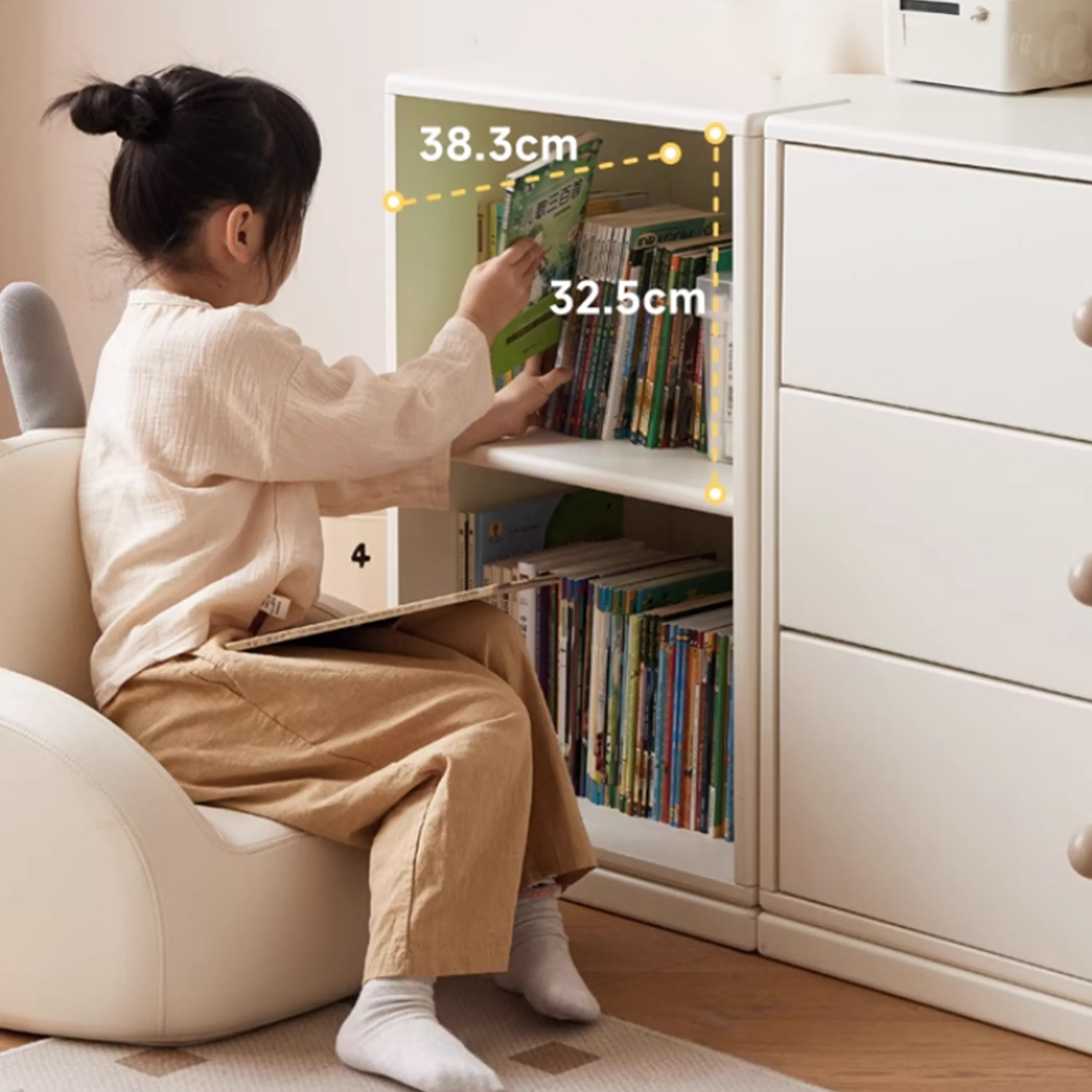 Mika Kids 2 Tier Open Shelf - 9 - young girl sitting on chair, reading book, holding book, sitting in white chair, sitting