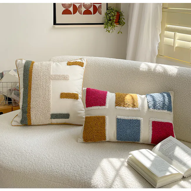 Alivia Cushion Cover - 5 - Soft, textured pillows in shades of beige, gray, green, and yellow, placed on a cozy white sofa.