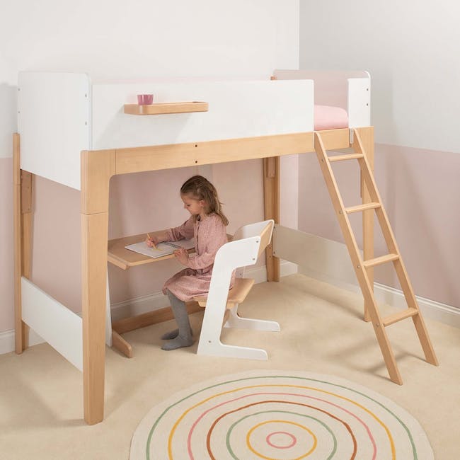 Natty Boori Single Loft Bed - Cherry & Almond - 3 - Wooden bunk bed with white frame, child sitting at desk, pink cushion on