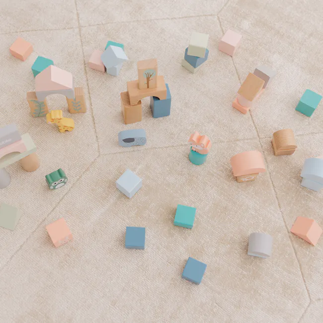 Bubble Wooden Activity Blocks - 4 - Soft pastel-colored wooden blocks scattered on a textured carpet, featuring various