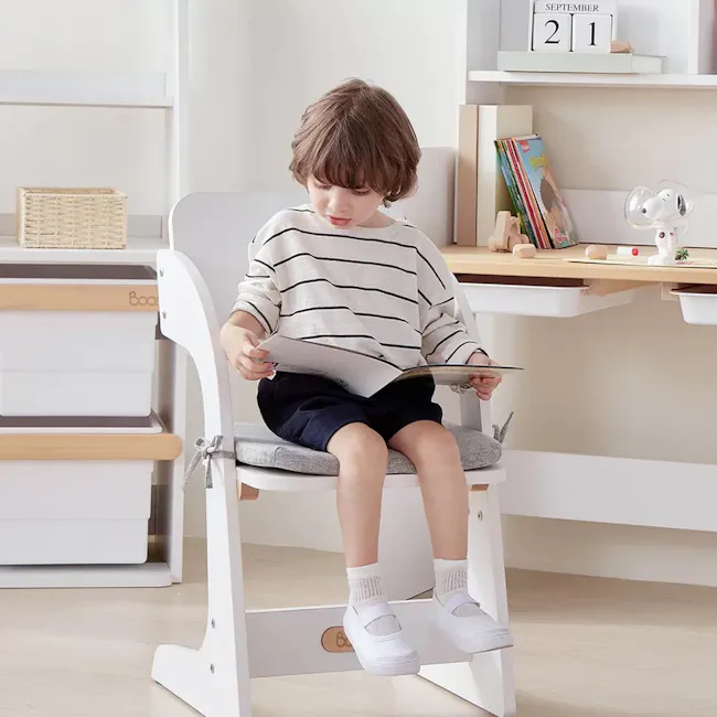 Natty Adjustable Study Chair - Blueberry - 7 - child sitting on chair, reading magazine, white chair, striped shirt, navy