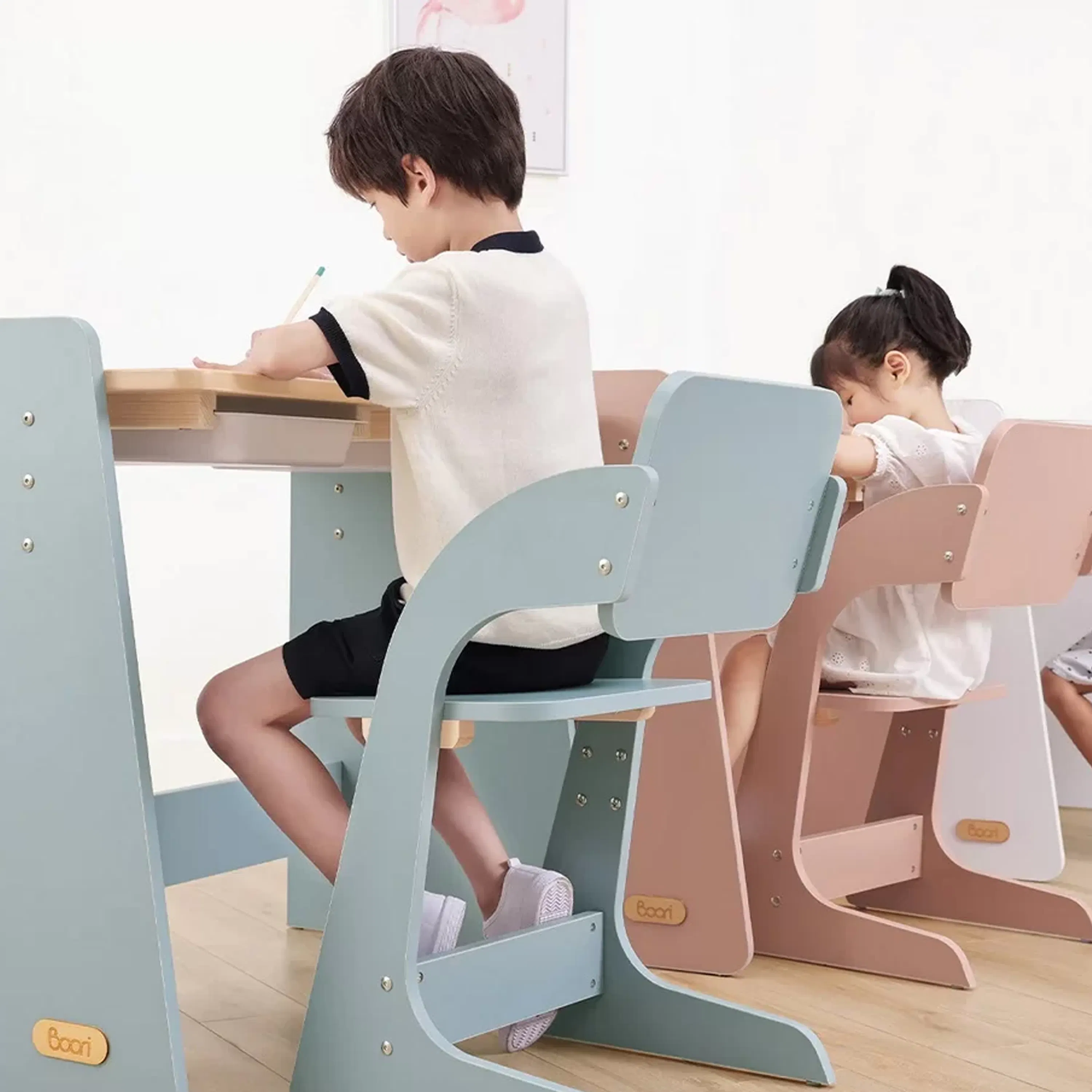 Natty Adjustable Study Chair - Cherry - 9 - Children sitting at modern, child-friendly desks, one boy and one girl, both