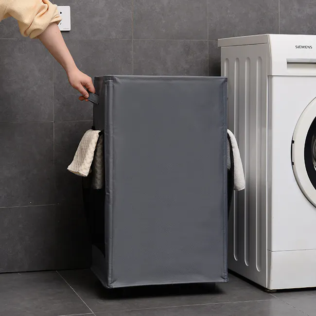 Mason Laundry Hamper with Wheels - Black - 2 - Gray refrigerator, person opening door, gray fabric, white towel, tiled wall