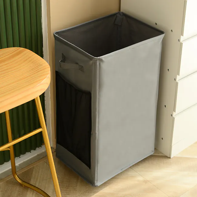 Mason Laundry Hamper with Wheels - Black - 4 - Gray laundry basket, beige wall, wooden stool, green radiator, light wooden