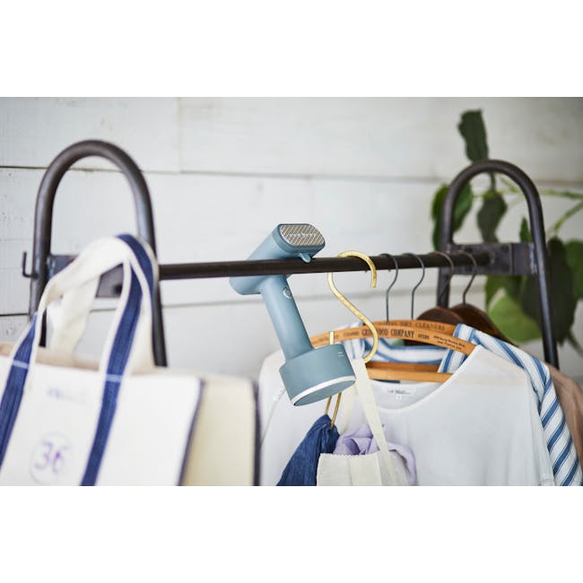 BRUNO Styling Handy Steamer - Mint Green - 3 - Shoe shine tool, blue hair dryer, hanging clothes, white and blue striped