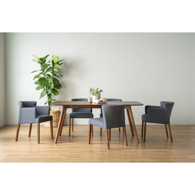 Roden Dining Table 1.8m - Cocoa - 5 - Modern dining room with wooden table and chairs, light gray walls, large green plant