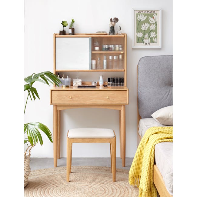 Zoie Dressing Table 0.55m - 6 - Wooden vanity with makeup items, green potted plant, framed poster on wall, wooden shelf