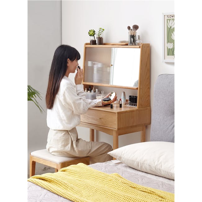 Zoie Dressing Table 0.55m - 2 - White room, woman makeup, sitting on stool, white blouse, beige pants, wooden dresser