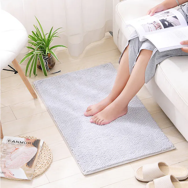 Cora Chenille Big Bath Mat - Light Grey - 3 - Comfortable living room setting with a light-colored rug, Person reading a