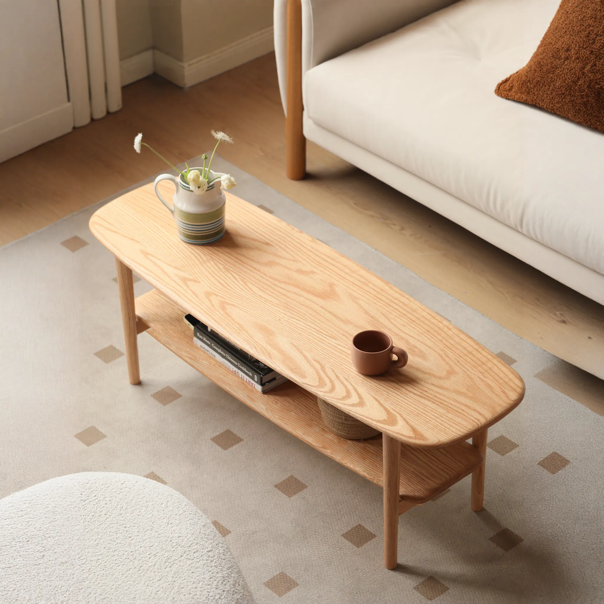 Nigel Narrow Coffee Table 1m - 12 - Wooden coffee table, beige carpet, geometric pattern, small brown cup, white ceramic