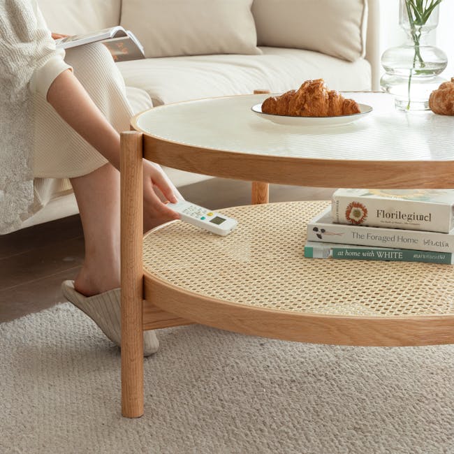 Lilian Rattan Coffee Table - Natural (Glass Tabletop) - 13 - Couch, person, reading, book, croissant, table, remote control
