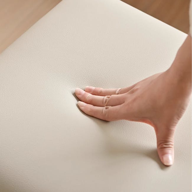 Xena Stool - Oak, Cream (Faux Leather) - 9 - Hand resting on smooth, beige surface, palm facing up, fingers spread apart