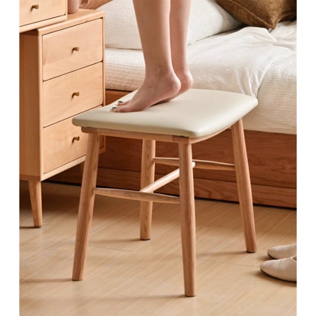 Xena Stool - Oak, Cream (Faux Leather) - 7 - Wooden nightstand, beige cushioned stool, person standing, barefoot, wooden