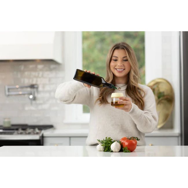 Zuutii Oil Dispenser with Brush - Light Cream - 7 - smiling woman pouring beer, kitchen with modern design, fresh vegetables