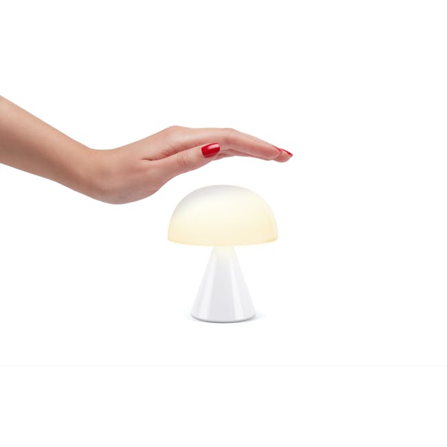 Lexon MINA M Led Lamp - Glossy White - 13 - White lamp with soft yellow light, hand gently touching, red nail polish
