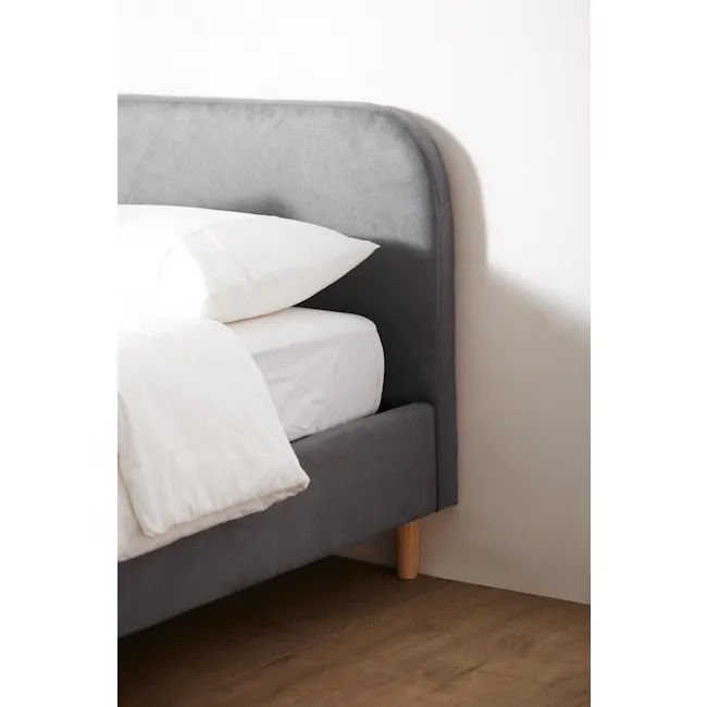 Nolan King Bed - Hailstorm - 6 - Grey upholstered headboard, white pillows, wooden floor, minimalist design, soft lighting