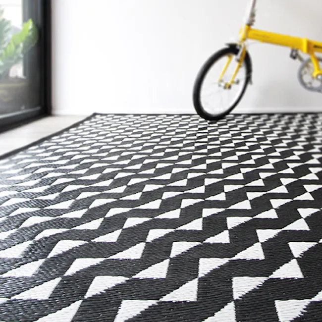 PDM Stride Reversible Mat (3 Sizes) - 5 - Yellow bicycle parked on a black and white chevron-patterned rug, Modern interior