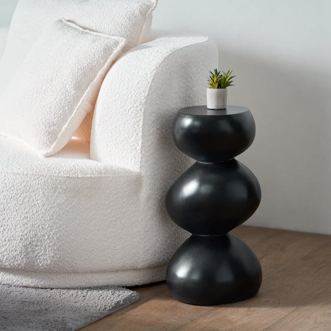 Stack Concrete Side Table - Black - 2 - White textured sofa, black stacked table, green potted plant, soft lighting