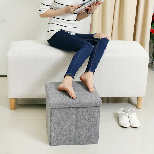 Domo Foldable Storage Cube Ottoman - Grey - 7 - striped shirt, jeans, ripped jeans, white sneakers, gray ottoman, barefoot