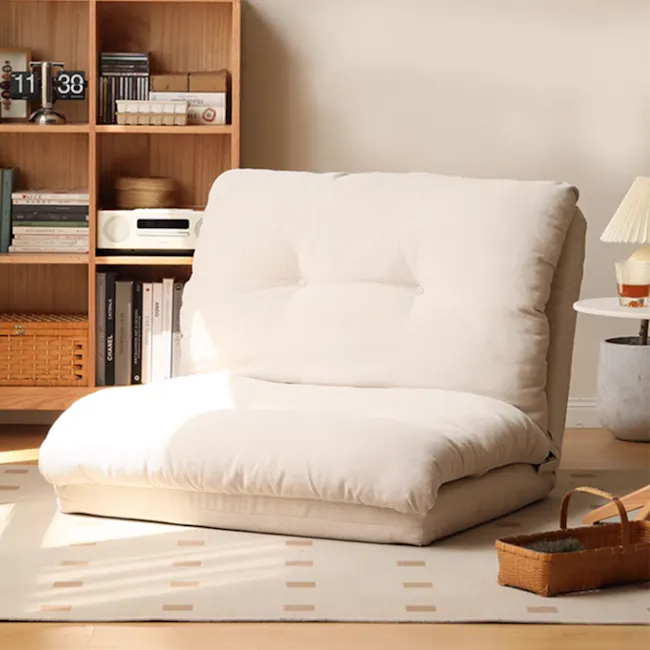 Jesse Sofa Bed - Cream Corduroy - 8 - Wooden bookshelf, white cushioned chair, minimalist decor, natural light, cozy room