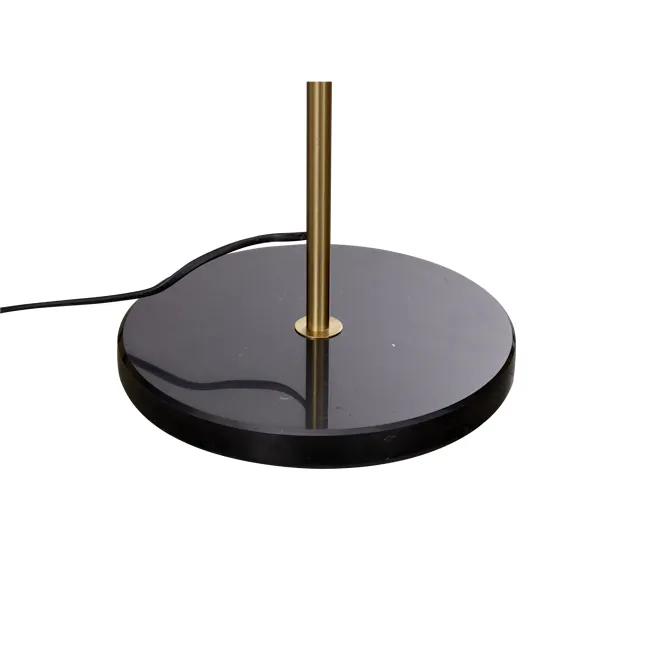 Kordi Floor Lamp - 5 - Gold pole, black table, glossy surface, circular design, reflective surface, industrial setting