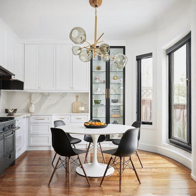 Carmen Round Dining Table 1m - White - 7 - Modern kitchen with sleek white cabinetry, elegant chandelier, round dining table