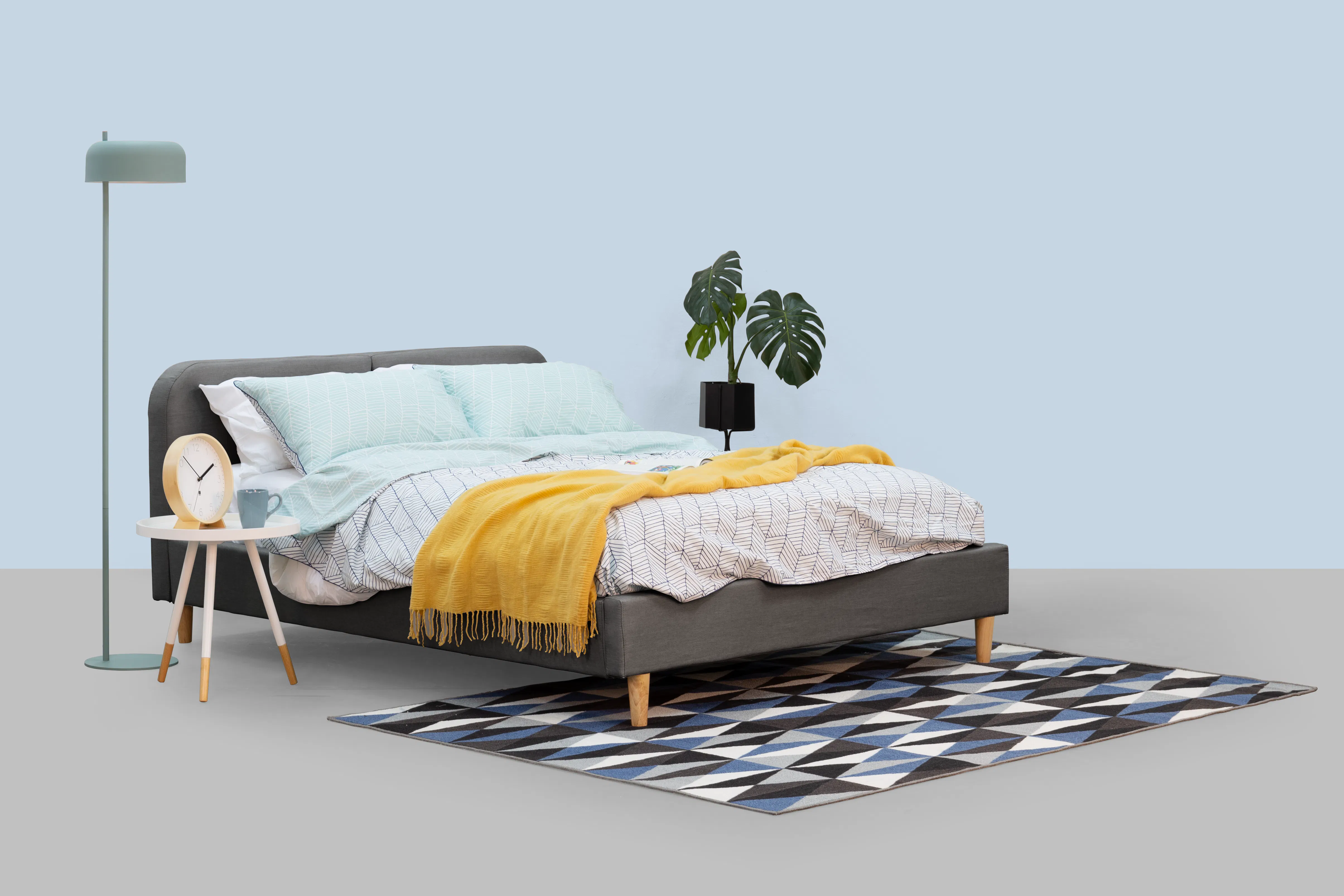 Nolan Single Bed - Hailstorm - 17 - Modern minimalist bedroom, light blue walls, cozy bed with gray headboard, yellow