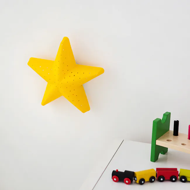 Kids Shiny Star Wall Lamp - 5 - Yellow star-shaped decoration, colorful toy trucks, wooden shelf, green and black toy cars