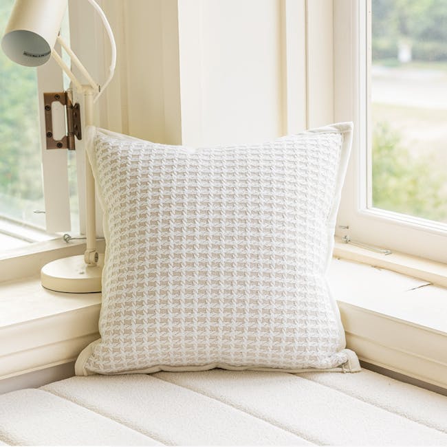 Tanisha Textured Waffle Weave Cushion - Cream - 2 - White textured pillow, natural light streaming through window, cozy room