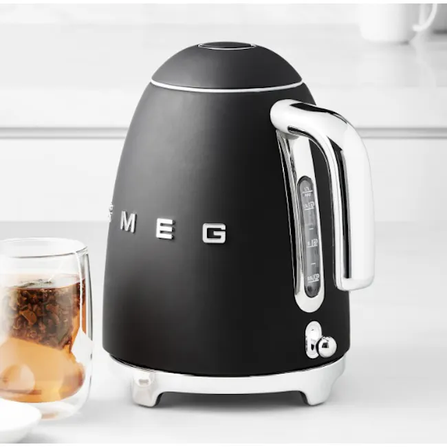 Smeg 1.7L Kettle - Matte Black - 2 - Black electric kettle with sleek design, Mug filled with iced coffee beside black