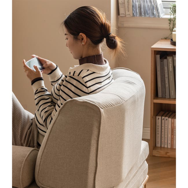 Zara Sofa Bed - Gravel White - 9 - striped sweater, beige armchair, indoor setting, woman sitting, brown hair bun, indoor