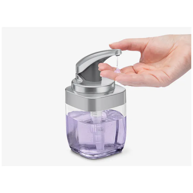 simplehuman 15oz Push Pump - 2 - silver faucet, hand holding dropper, liquid dispensing, purple bottle, soap dispenser