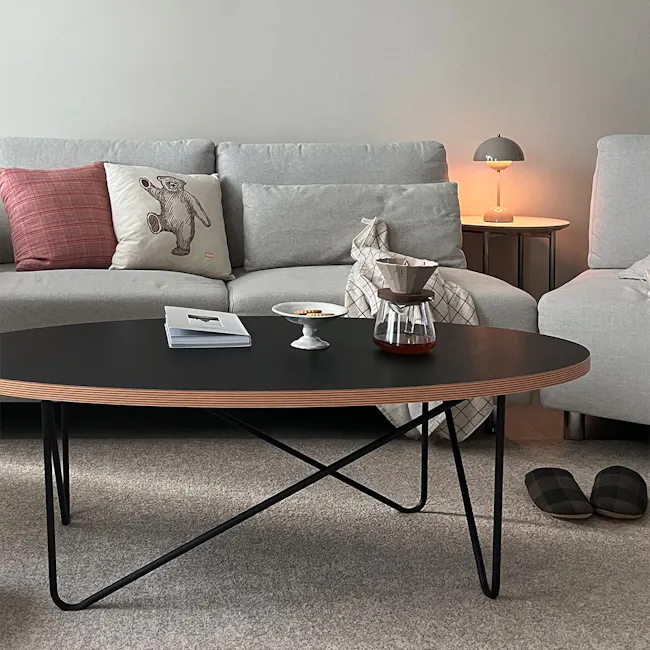 Seifer Coffee Table - 5 - modern living room, cozy seating, gray sofa, plaid pillows, black coffee table, minimalist decor