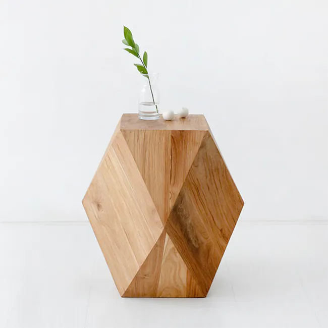Dax Stool Side Table - 9 - Durable wooden hexagonal table, natural light illuminates, clear glass vase with green leaves