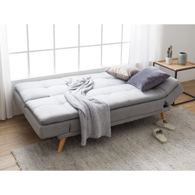 Kara 3 Seater Sofa Bed - Pigeon Grey - 8 - Light gray sofa, light wooden legs, beige cushions, gray knitted blanket, white